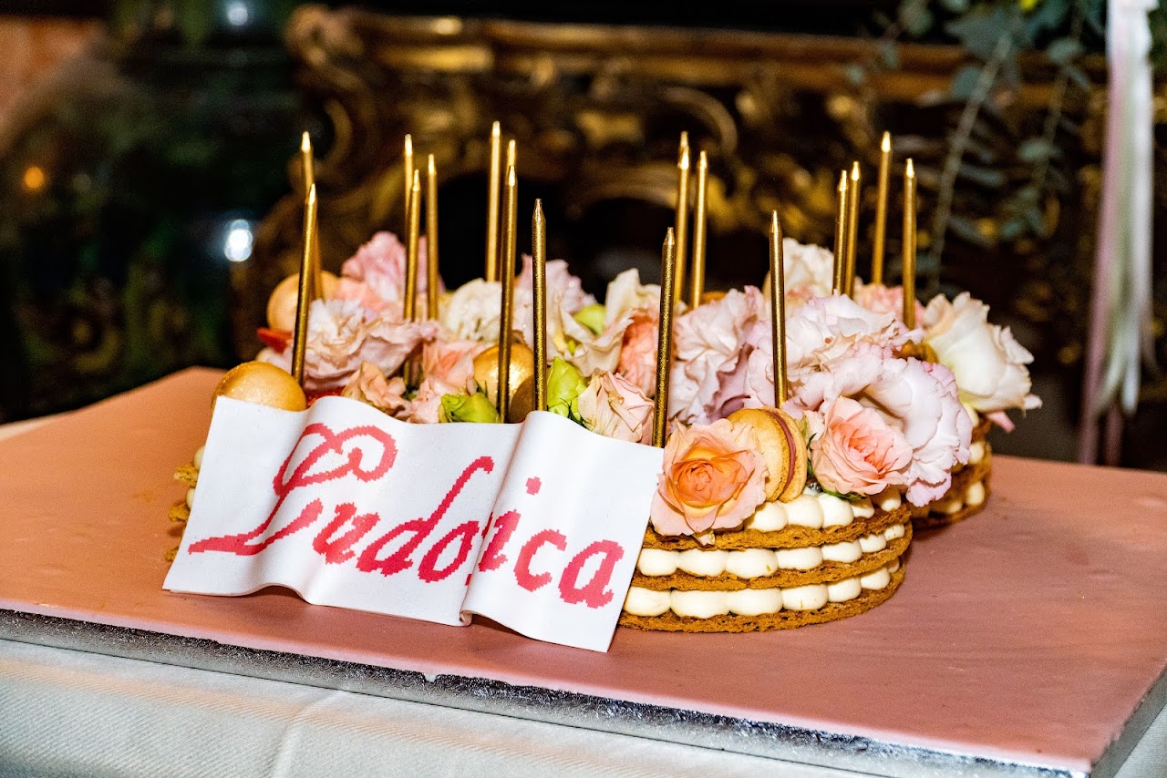 Candlelit birthday cake on wooden platter