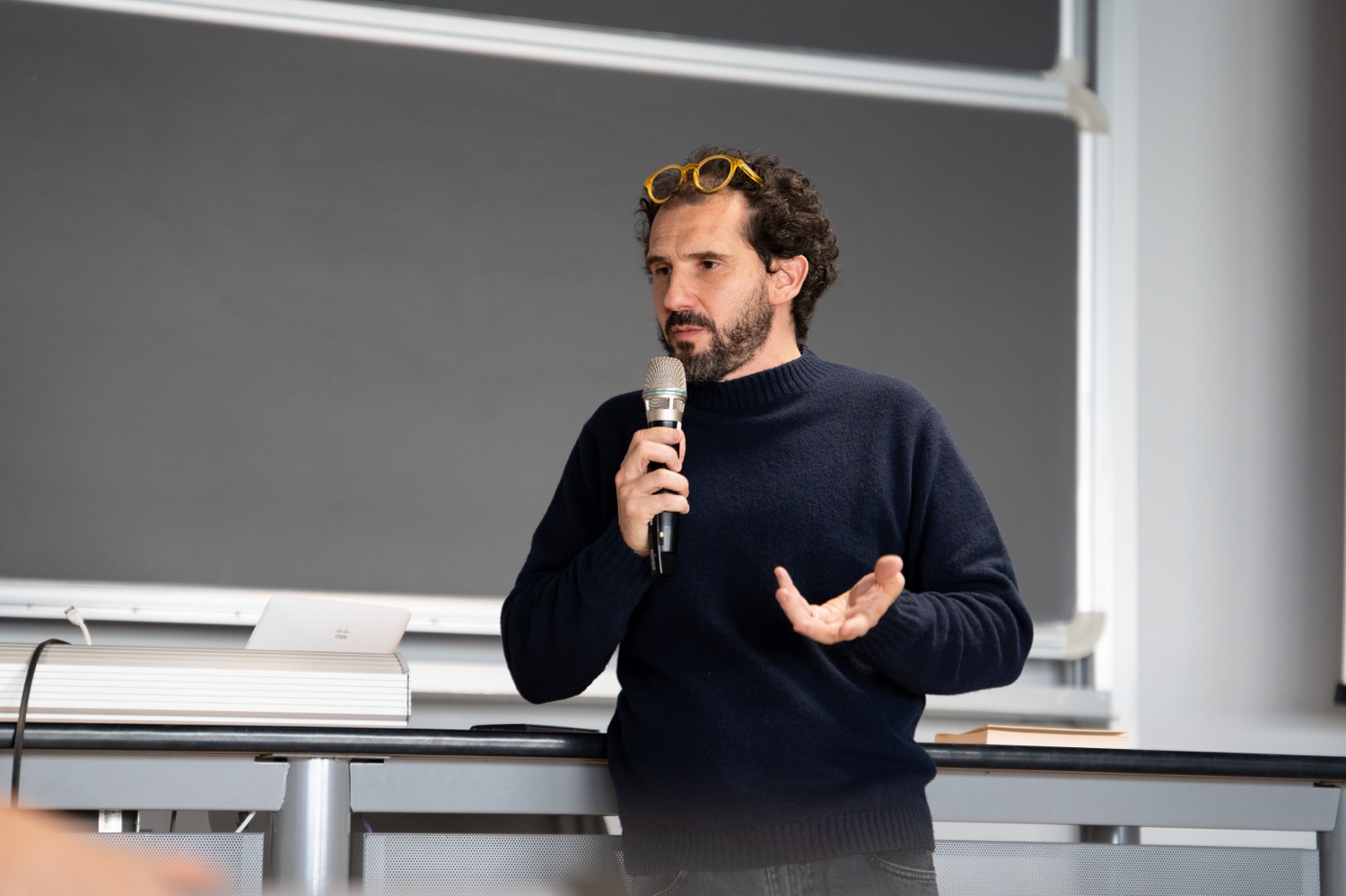 Person wearing clothes holding microphone