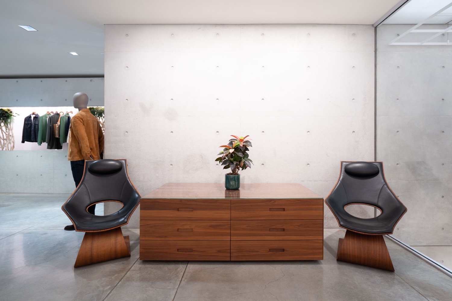 Person stands in front of processed wooden furniture
