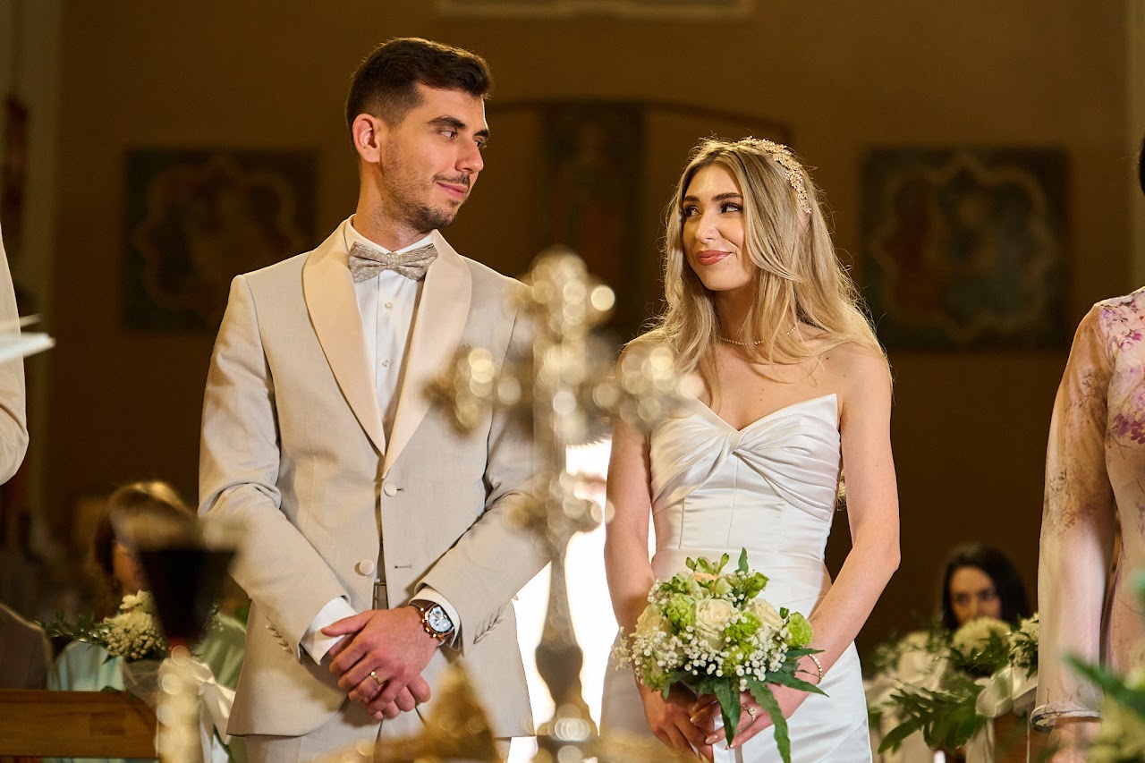 Person stands next to ivy covered archway